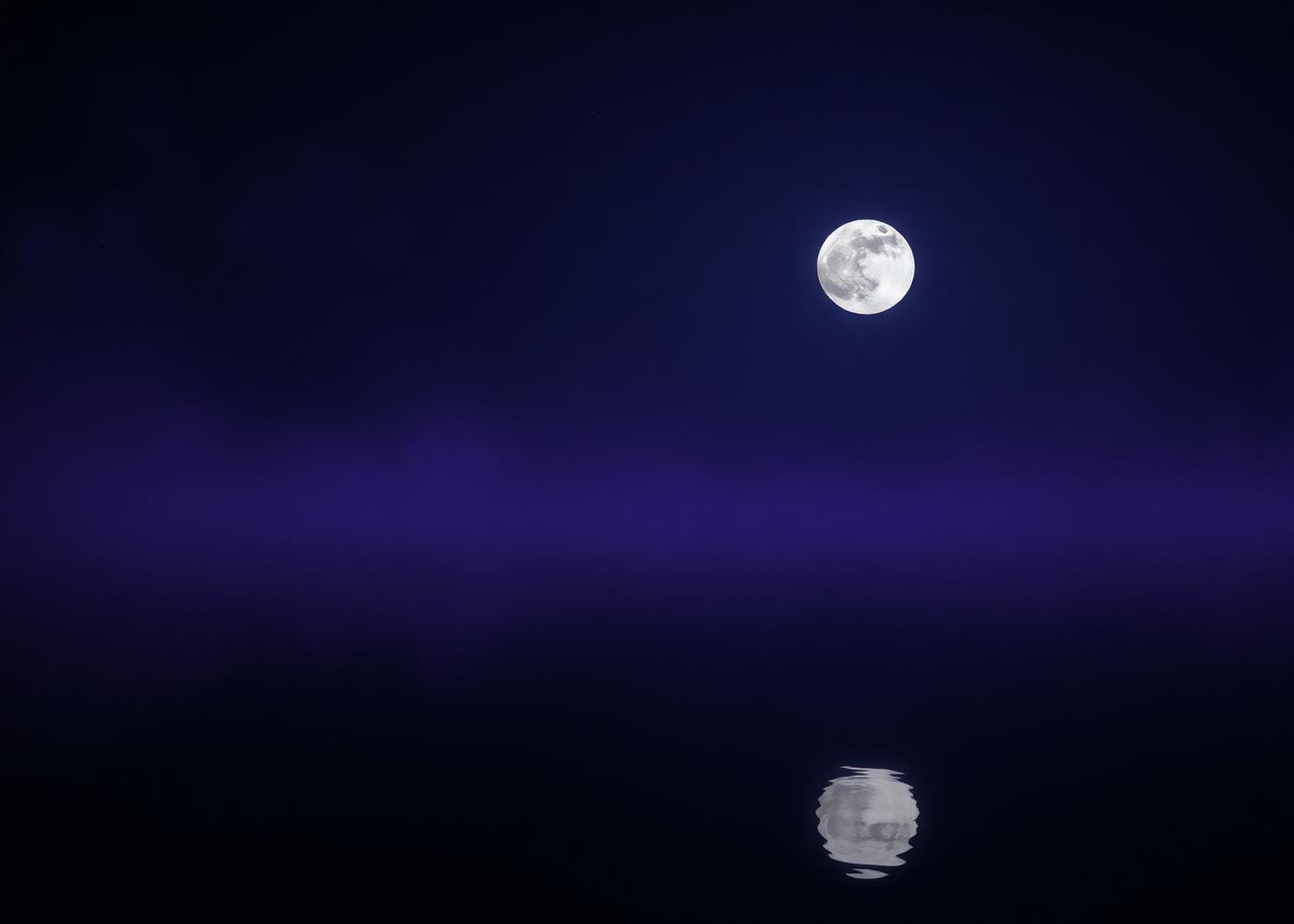 A pale moon reflected on still black water